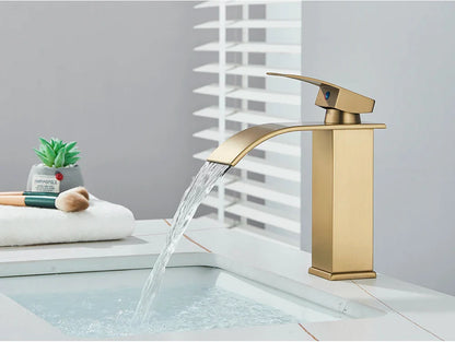 Gold-toned bathroom sink faucet brass deck mount with sleek modern design and stainless steel brushed metal finish