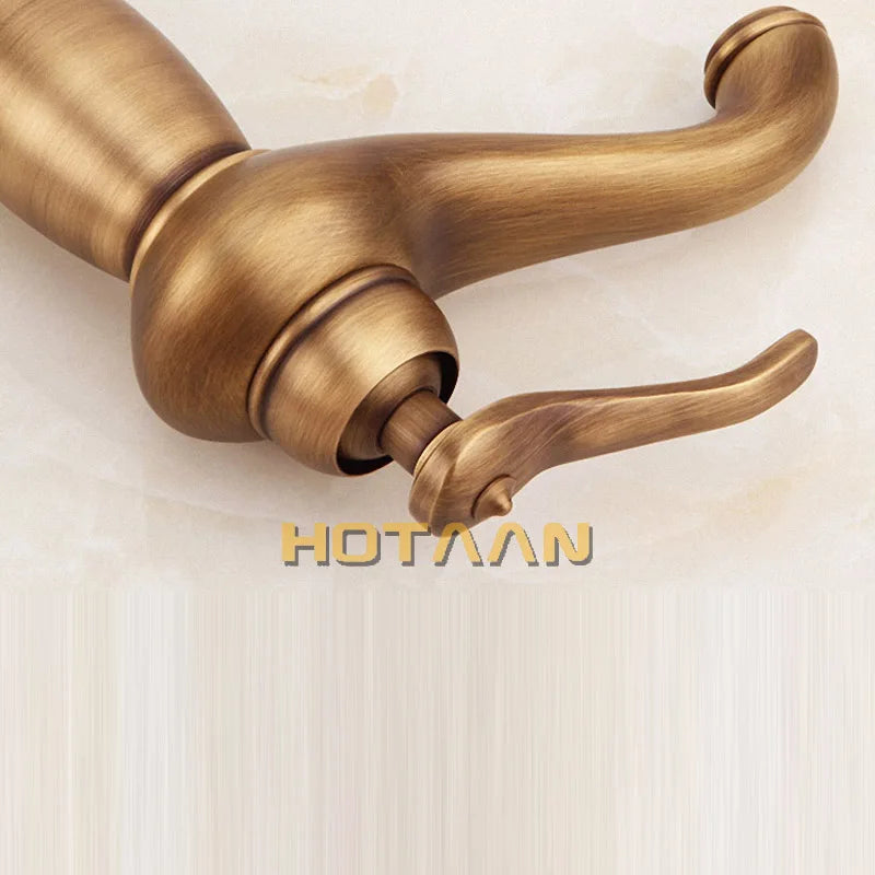 Antique brass-finished bathroom tall basin faucet with single handle and curved spout in vintage-inspired design