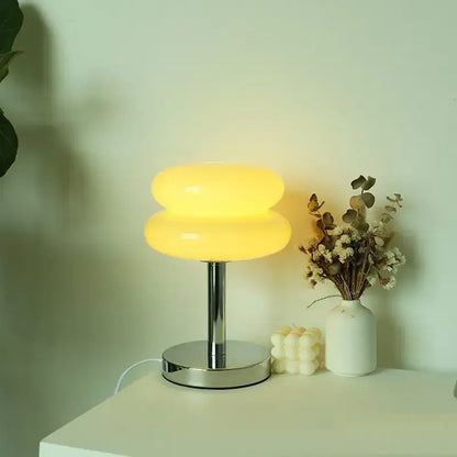 Bauhaus glass table lamp with a warm yellow translucent glass shade and sleek chrome base for bedroom lighting