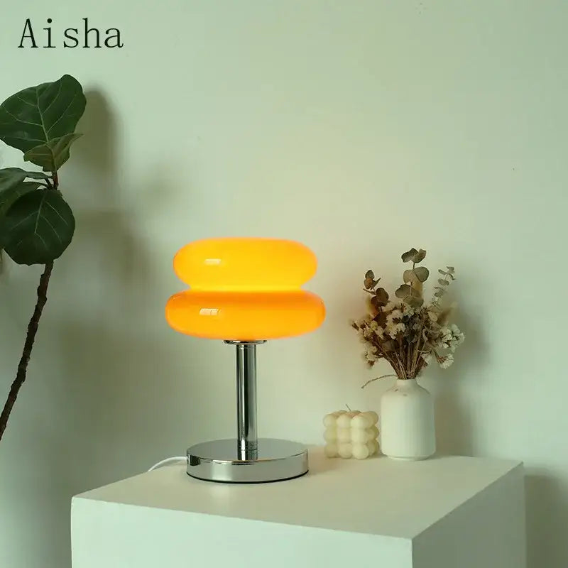 Vibrant orange bauhaus glass table lamp with double-donut shape and chrome base for bedroom lighting