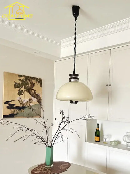 Bauhaus cream glass pendant light with cream-colored dome, black coiled chain, and metallic accents for kitchen decorbites pendant lights