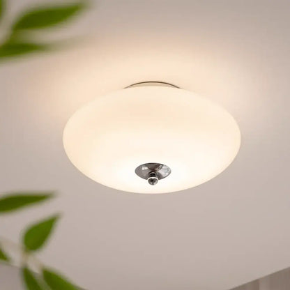 A modern bauhaus cream white glass ceiling lamp with frosted shade and polished chrome fixture for dining room decorbites