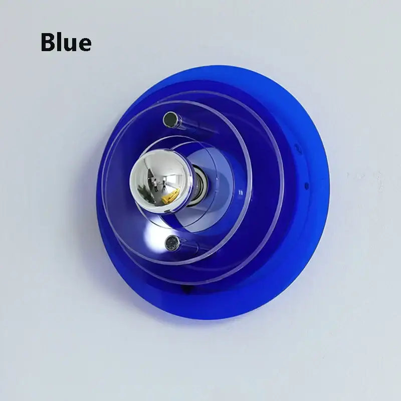Vibrant blue bauhaus led wall sconce with concentric clear acrylic rings and chrome bulb for bedroom or living room use