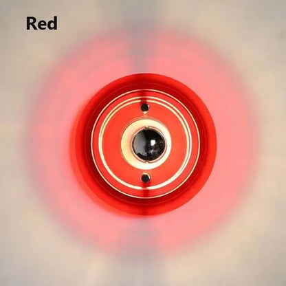 Red circular bauhaus led wall sconce with concentric rings and central black sphere for bedroom and living room