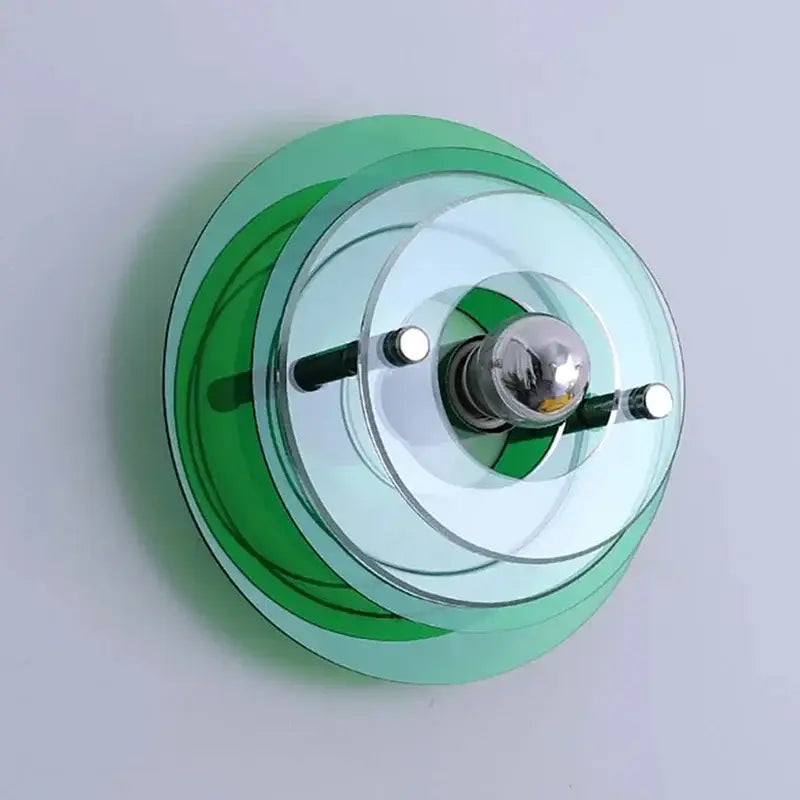 Modern bauhaus led wall sconces featuring circular green and clear glass rings with chrome bulb holder for bedroom or living room
