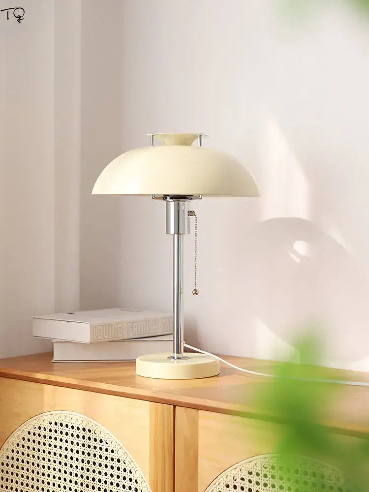 Cream-colored bauhaus led table lamp with sleek chrome stem and base for bedroom or living room lighting