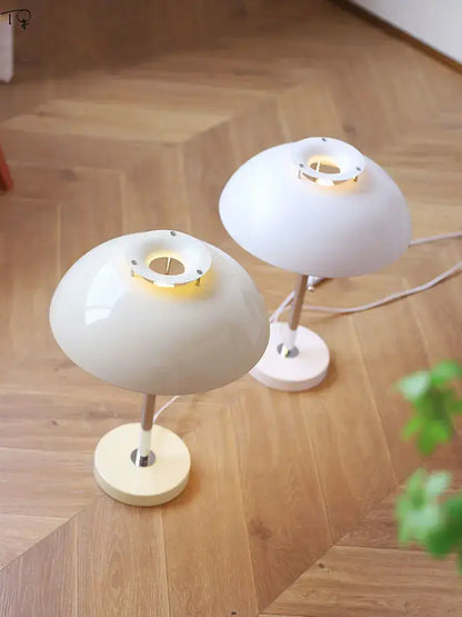 Two minimalist white bauhaus led table lamps with metallic stems and warm glow for bedroom or living room lighting