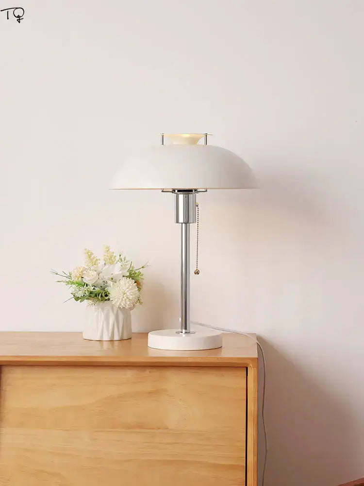 White ceramic bauhaus led table lamp with sleek chrome stem and pull-chain switch for bedroom or living room use