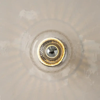 Clear glass bauhaus led wall sconces with gold-toned metallic rim and reflective center for aisle lighting