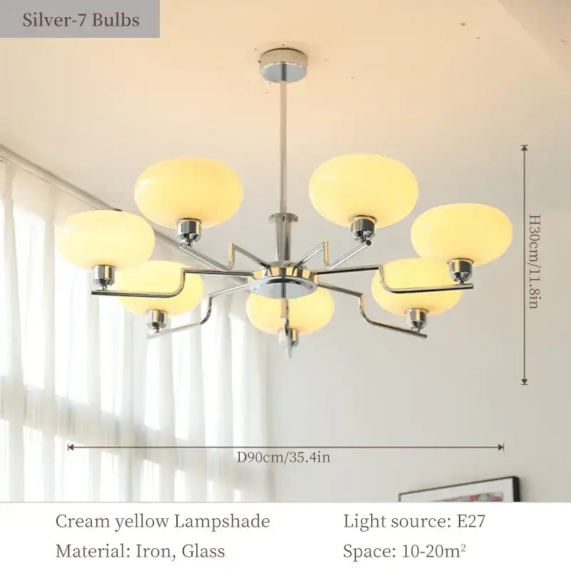 A bauhaus medieval chandelier with seven cream yellow glass lampshades and a polished iron frame for living room light