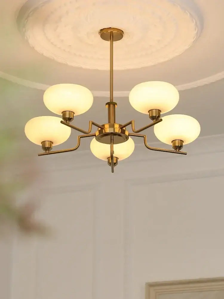 Brass-finished bauhaus medieval chandelier with five frosted glass globes for living room lighting