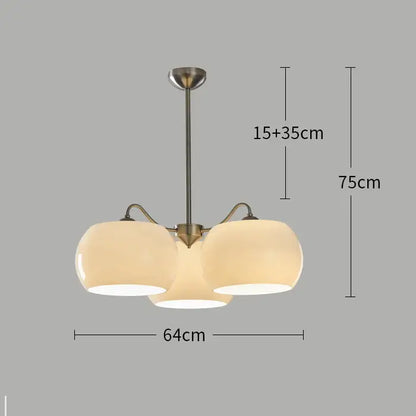 Modern brass-finished persimmon chandelier with three frosted glass globe shades for dining room lighting
