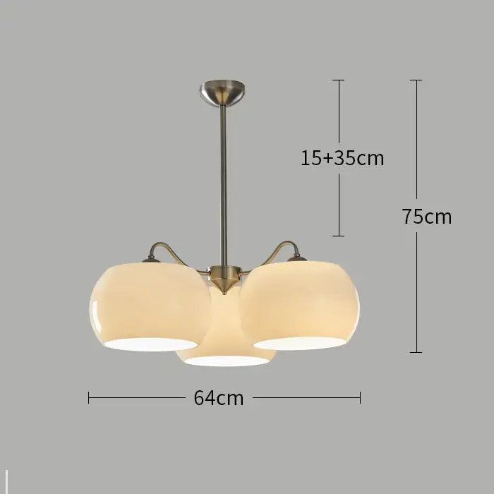 Modern brass-finished persimmon chandelier with three frosted glass globe shades for dining room lighting
