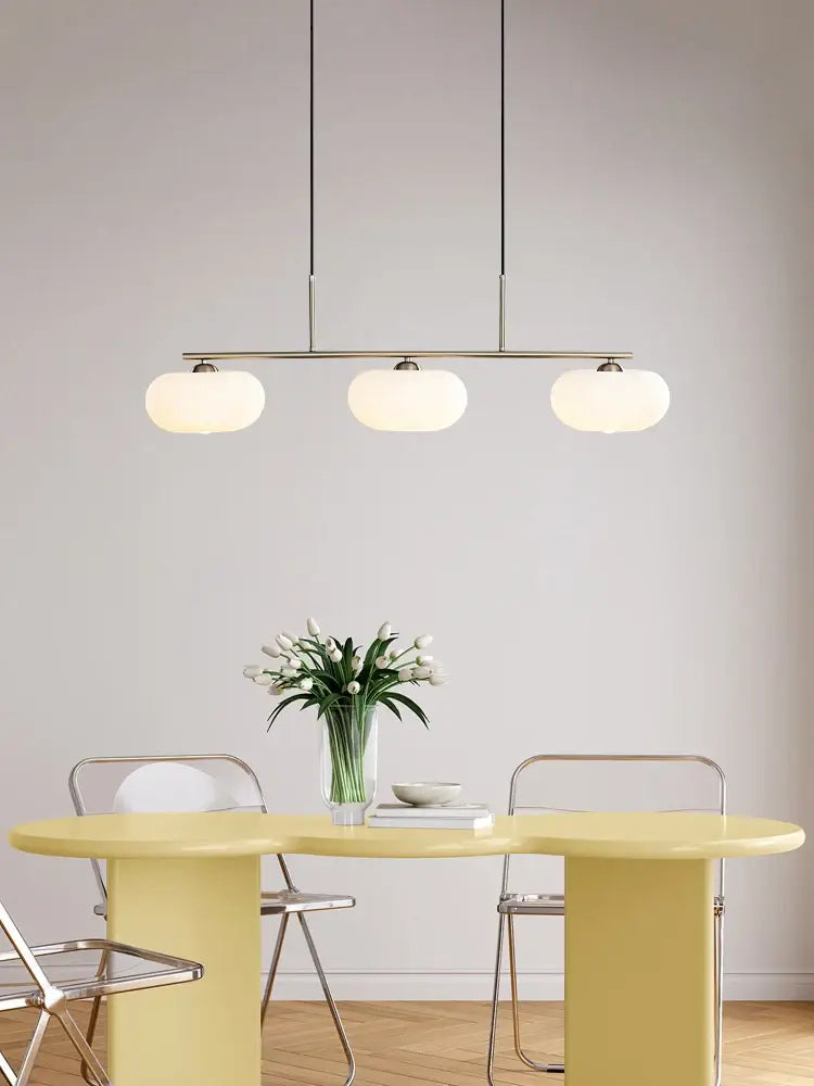 Modern minimalist glass persimmon chandelier with three frosted milk white glass globes for dining room lighting
