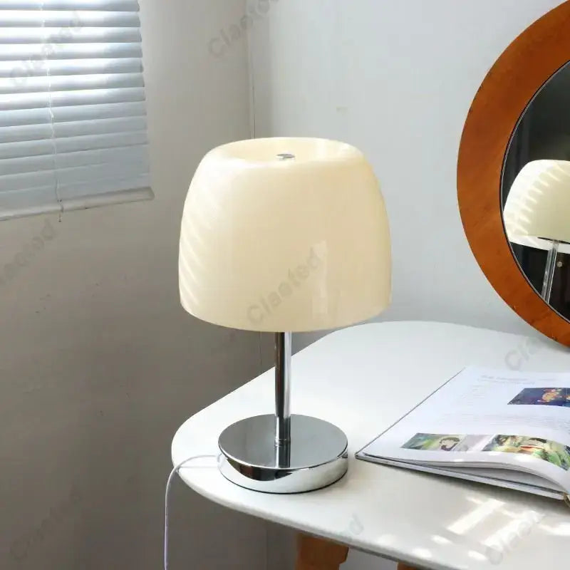 Cream-colored glossy acrylic lampshade bauhaus retro table lamp with sleek chrome base for bedroom use