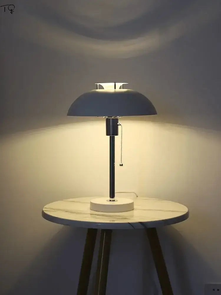 A bauhaus led table lamp with a matte gray dome shade and white marble base for bedroom use
