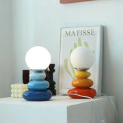 Two colorful stacked-glass globe bauhaus table lamps with smooth glossy finishes for modern interior lighting