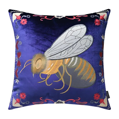 A navy blue velvet cushion cover with intricate bee embroidery and floral motifs for living room decor