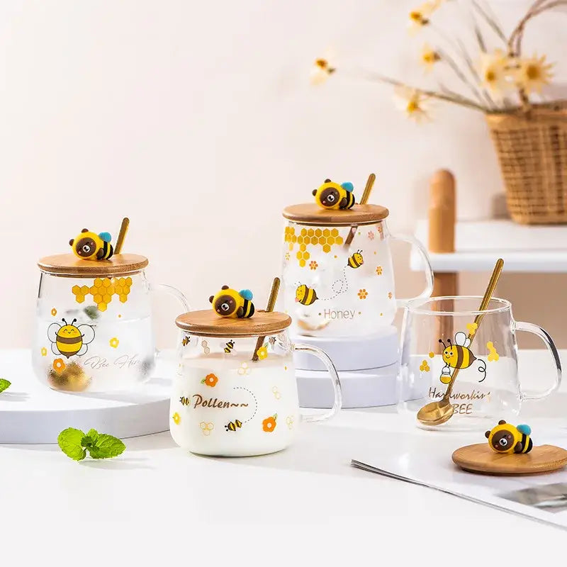 Clear glass bee glass spoon milk cup with bamboo lid and golden spoon featuring yellow bee honeycomb design
