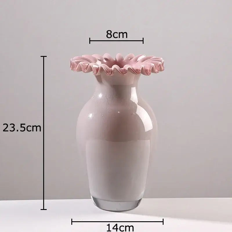 A delicate blush pink glass vase with a pink flower edge rim and smooth rounded body for living room decor
