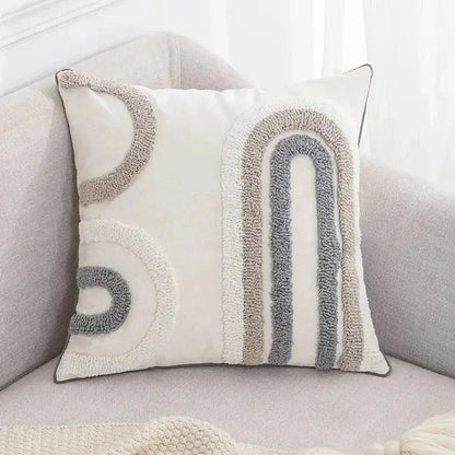 Beige and white cushion cover with decorbites geometric embroidery tassel featuring cream tufted rainbow patterns
