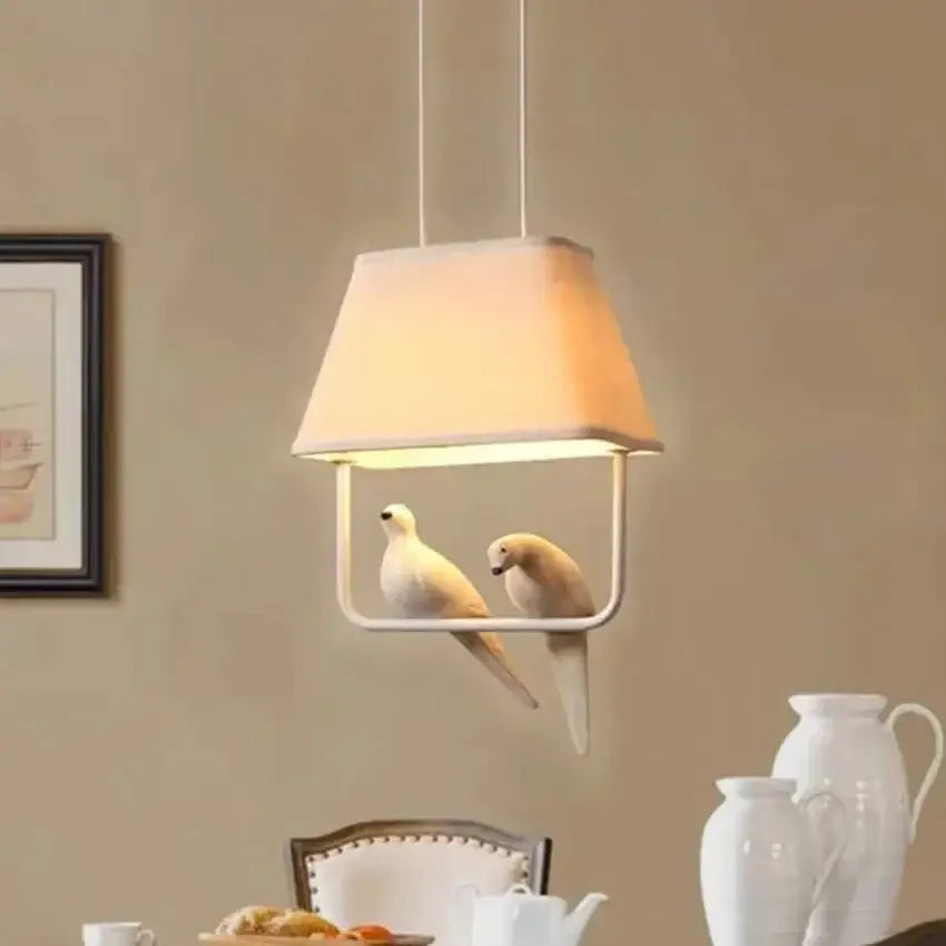 Beige bird cloth chandelier with white fabric shade and sculpted doves in minimalist metal frame for dining room decorbites bird cloth