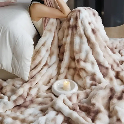 A beige and brown faux fur decorbites cozy fleece throw blanket with a soft mottled pattern for bedroom use