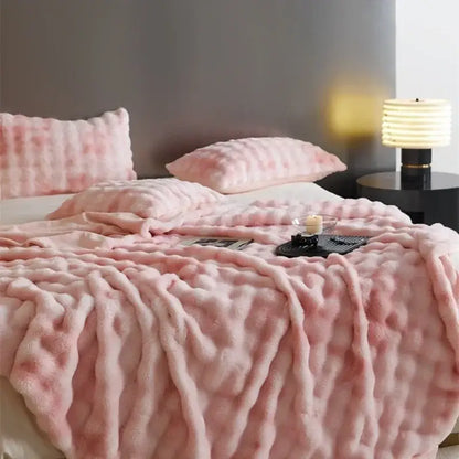 Pink plush throw blanket with textured fluffy surface made of decorbites cozy fleece for bedroom decor