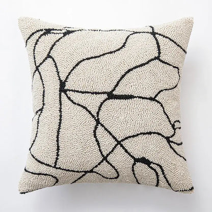 Cream-colored textured cushion cover with abstract black geometric line art for elegant decorbites decorbites geometric line design