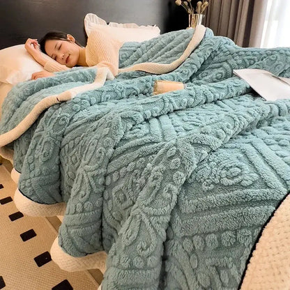 A plush teal fleece warmth blanket with a raised geometric floral pattern and cream inner lining for decorbites carved velvet