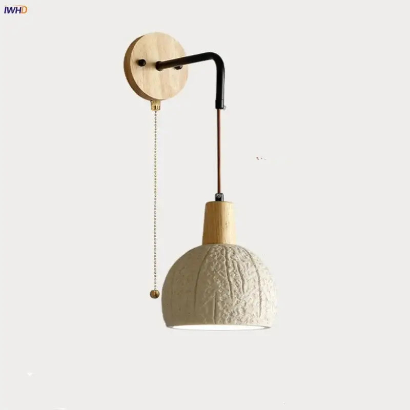 Beige textured ceramic wall sconce with decorbites cement shade wood and black arm for bedroom decor