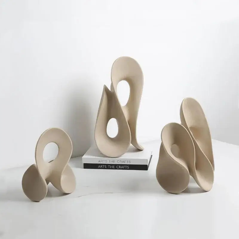 Beige ceramic coral hollow sculpture with smooth flowing curves and central circular opening for living room decorbites coral hollow decor