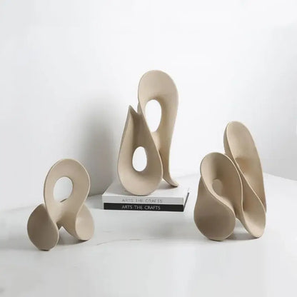 Beige ceramic coral hollow sculpture with smooth flowing curves and central circular opening for living room decorbites coral hollow decor