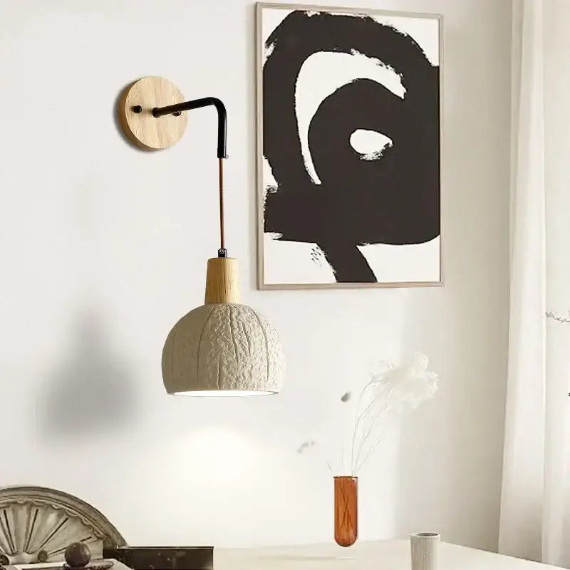 Beige ceramic wall sconce with textured off-white ceramic pendant lamp, wooden neck, and pull chain switch for bedroom