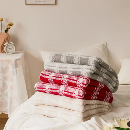 Stack of decorbites fluffy stripe microfiber throw blankets in red and gray stripe plaid patterns with white accents