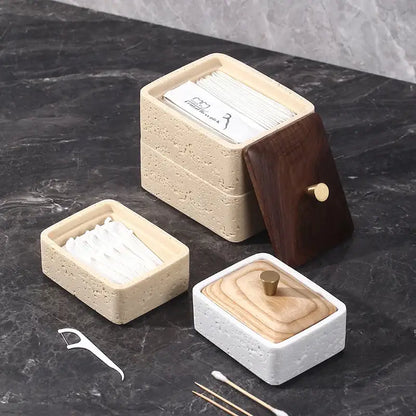 Beige and dark wood double decker natural stone jewelry organizer with textured concrete base holding dental floss packets