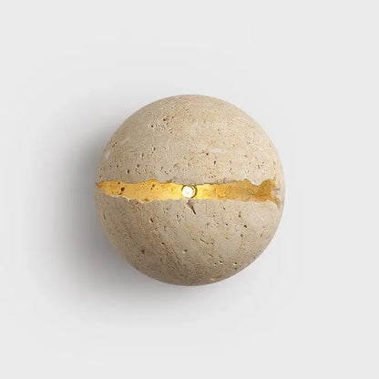 Beige dino egg stone wall lamp with textured concrete surface and gold leaf accent for bedroom decorbites dino egg wall lamp