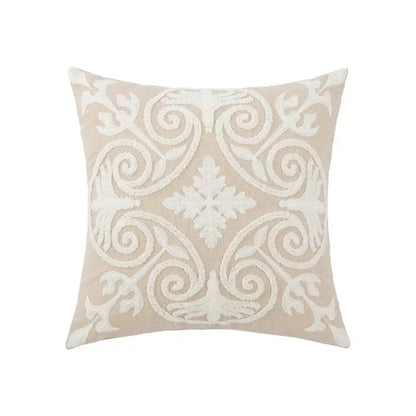 Beige square pillow cover with intricate white embroidered daisy floral and scrollwork design for bedroom decor