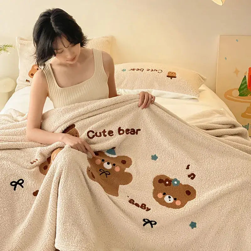 Beige embroidered teddy fleece blanket with cream plush fabric featuring cute bear embroidery for cozy teddy fleece decorbites