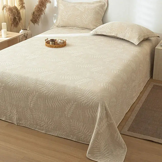 Beige cotton linen bed sheet set with a subtle raised fern leaf pattern ideal for bedroom bedding