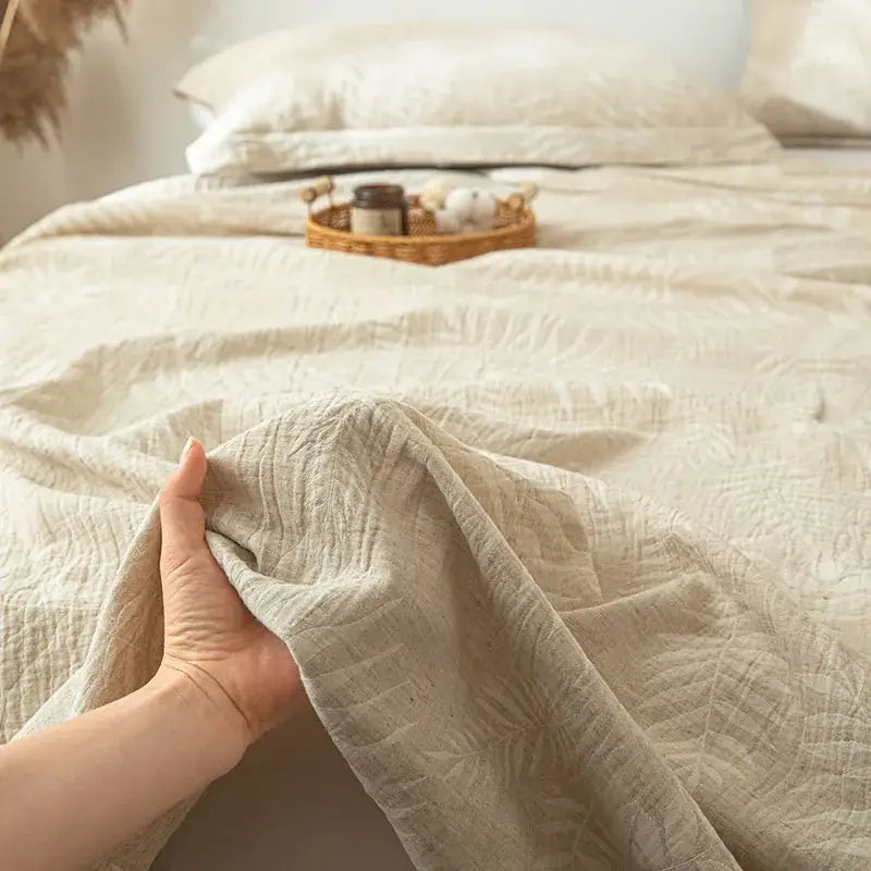 Beige textured cotton linen bed sheet set with subtle fern leaf pattern for bedroom bedding use