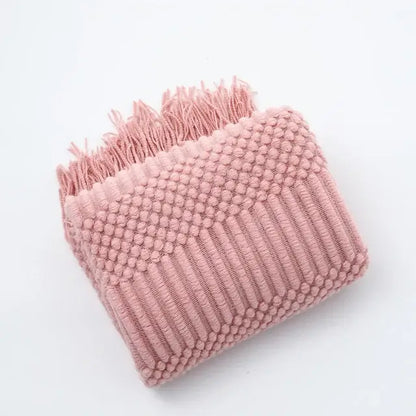 A soft pink knitted tassel blanket with textured dots and ridges by decorbites 3d knitted for bedroom decor