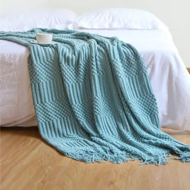 A soft light blue knitted tassel blanket with textured diamond pattern and fringed edges from decorbites 3d knitted