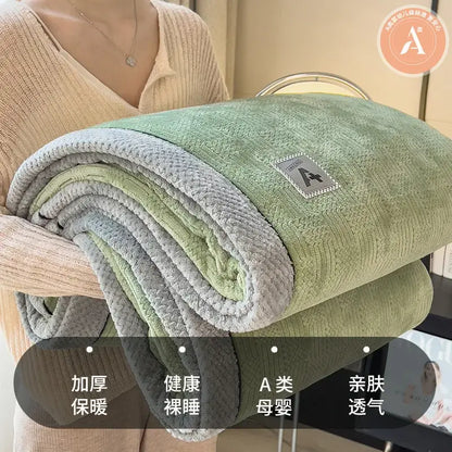 A soft plush green and gray velvet plush cotton blanket with textured surface and branded patch for bedroom throw