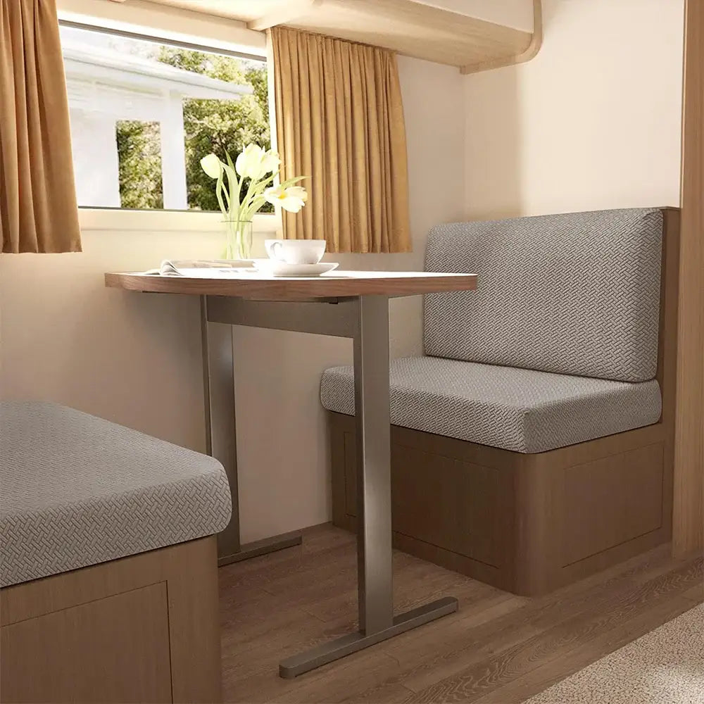 Beige jacquard woven rv sofa cover on light gray upholstered seating near a wooden table with sleek metal base