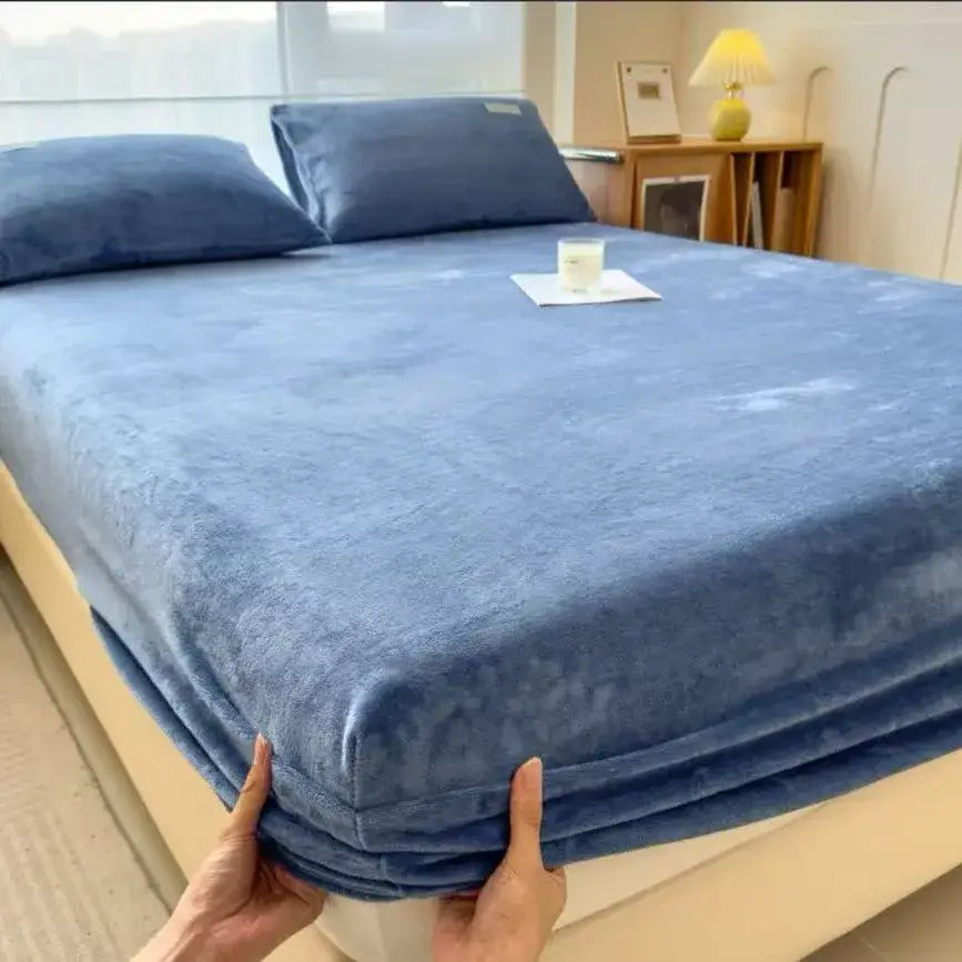 Blue plush fitted sheet with soft velvet texture and snug elastic edges for a milk velvet fitted mattress topper