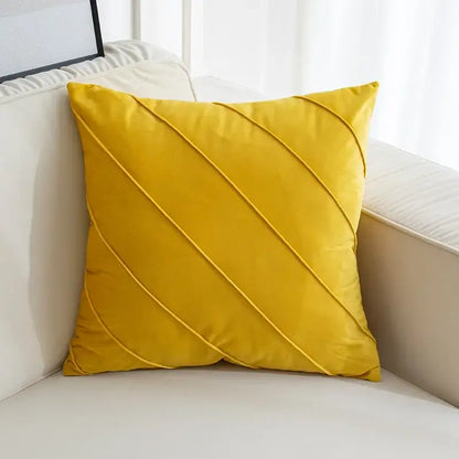 A vibrant mustard-yellow velvet throw pillow with diagonal hand pleat embroidered cushions for living room decor
