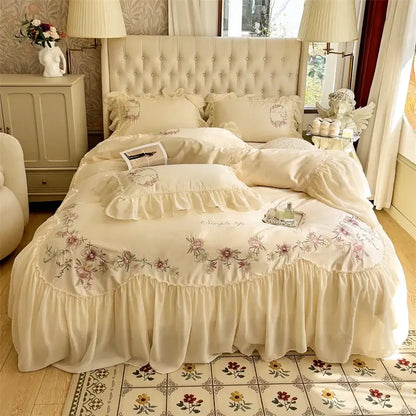 Cream-colored floral embroidered bedding set with ruffled edges and tufted headboard from decorbites beige pink lace collection