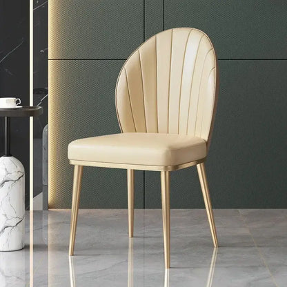 Beige leather dining chair with shell-shaped back and gold metal legs from decorbites dining set for dining room decor