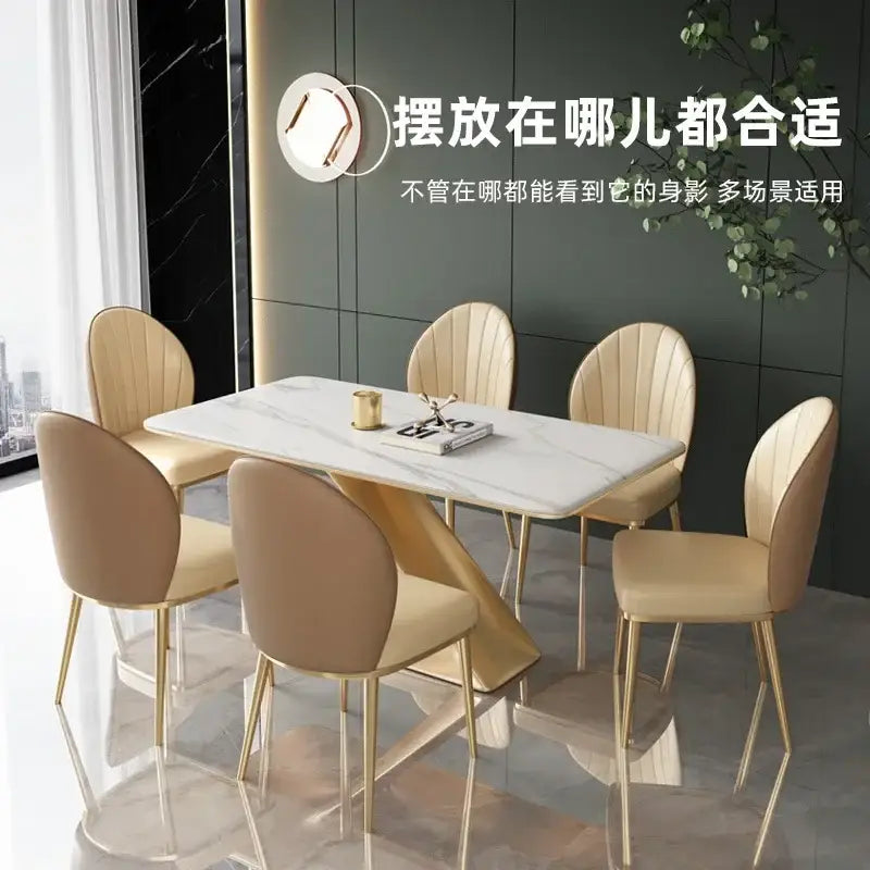 Beige pleated upholstered dining set with gold legs featuring a white marble table and gold geometric frame decorbites dining set